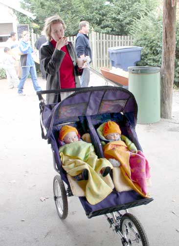 Little kids with pumpkin hats on!