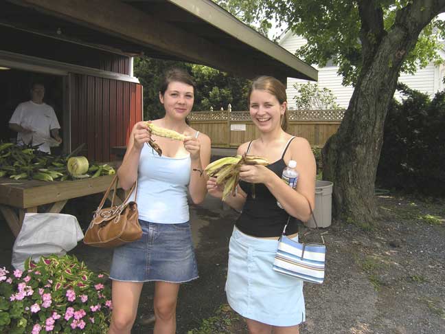 Girls eating sweet corn