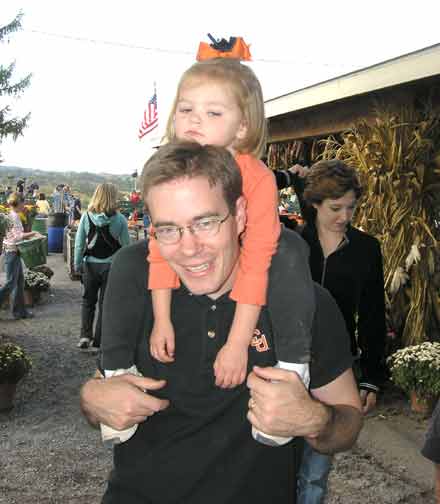 Little girl with Halloween spider on her head