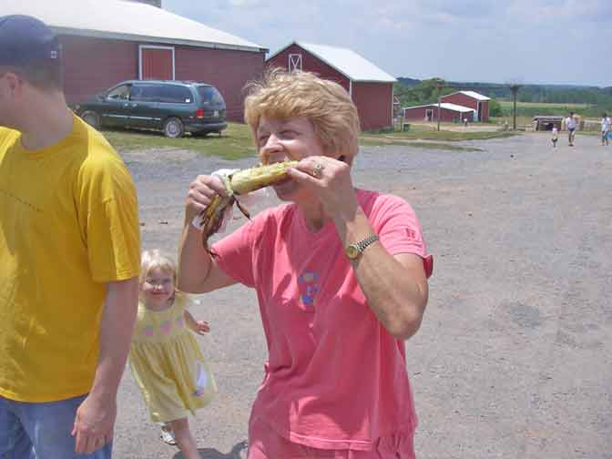 Joan eats roasted corn